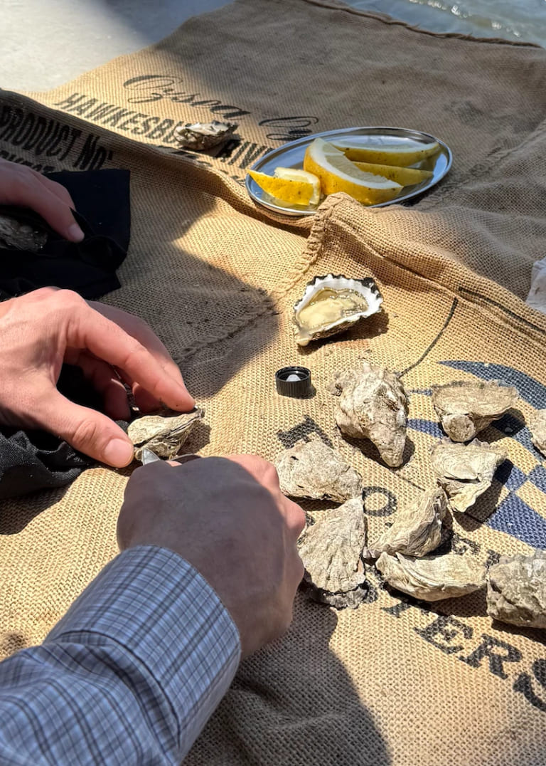 Guest shucking oysters on the boat
